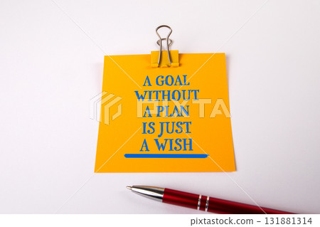 Yellow sticky note with motivational quote. A goal without a plan is just a wish 131881314