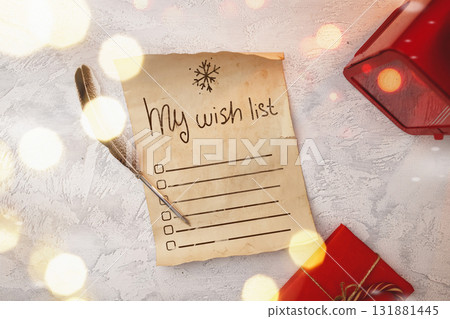 Creating a festive wish list with a feather quill and holiday gifts 131881445