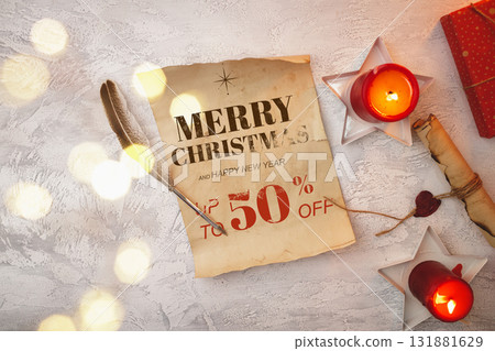 Christmas sale announcement with candlelight and decorative elements on a table 131881629