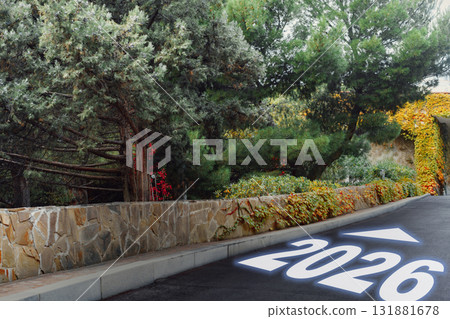 Pathway marked with the year 2026 amidst greenery in a tranquil setting 131881678