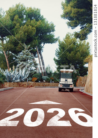 Golf cart driving down a narrow road surrounded by trees in a resort Golf cart driving down a narrow road surrounded by trees in a resort 131881814