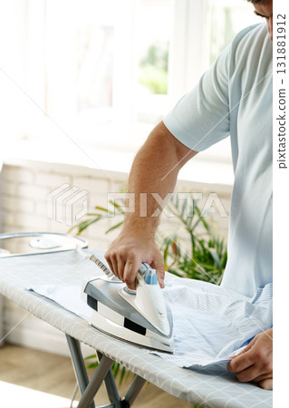 Ironing clothes at home in a bright and inviting space 131881912
