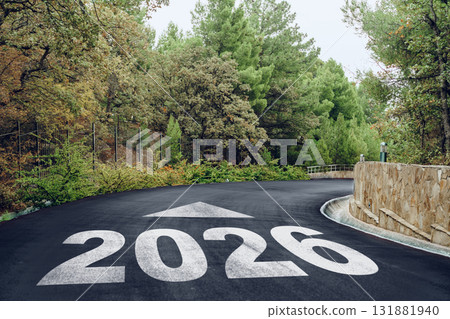 Road sign indicating the path to 2026 through a forested area on a winding road Road sign indicating the path to 2026 through a forested area on a winding road 131881940
