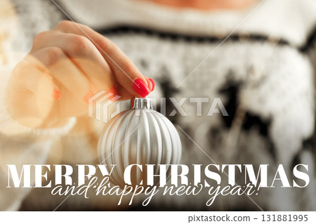 Creating holiday decorations with a silver ornament during festive season in cozy setting 131881995