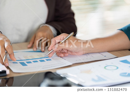 Collaboration and Business Strategy. Professionals discussing vital business metrics with focus on data analysis and cooperation. 131882470