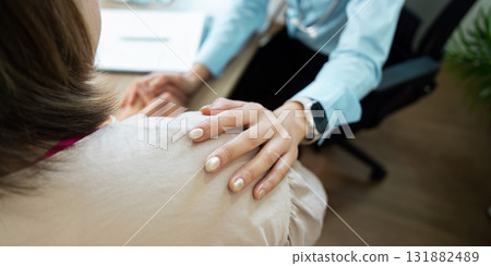 Emotional Support and Patient Care. A healthcare worker offers comfort to a patient during a consultation. Emotional Support and Patient Care. A healthcare worker offers comfort to a patient during a consultation. 131882489