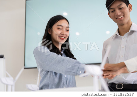 Positive Collaboration and Sustainability. Colleagues exchanging innovative ideas during a brainstorming session focused on renewable energy. 131882537