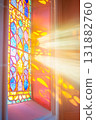 Colorful Stained Glass Window with Sunlight Casting Patterns on Wall. 131882760