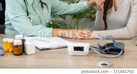 Healthcare and Compassion. An elderly doctor providing thoughtful care and consultation to a patient in a relaxed setting. Healthcare and Compassion. An elderly doctor providing thoughtful care and consultation to a patient in a relaxed setting. 131882762