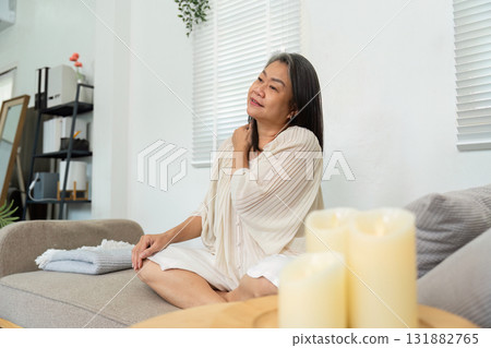 Mindfulness and Relaxation. A senior woman practices mindfulness while seated in a calm environment. Mindfulness and Relaxation. A senior woman practices mindfulness while seated in a calm environment. 131882765
