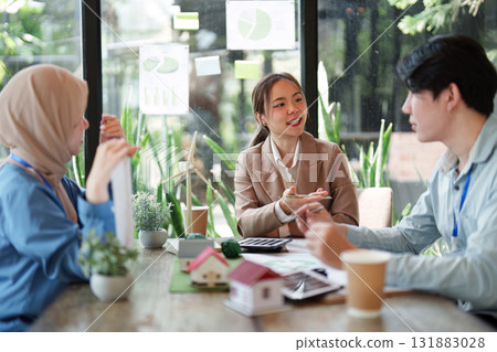 Empowering Sustainable Practices. A team discusses sustainable architecture and renewable energy solutions. Empowering Sustainable Practices. A team discusses sustainable architecture and renewable energy solutions. 131883028