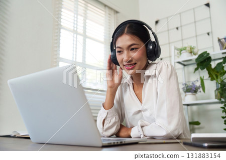 Virtual Meeting and Professionalism. A businesswoman connecting with her audience using headphones during an online meeting. Virtual Meeting and Professionalism. A businesswoman connecting with her audience using headphones during an online meeting. 131883154