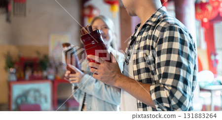 Cultural Discovery and Adventure. A couple exploring local snacks during their travel experience. 131883264