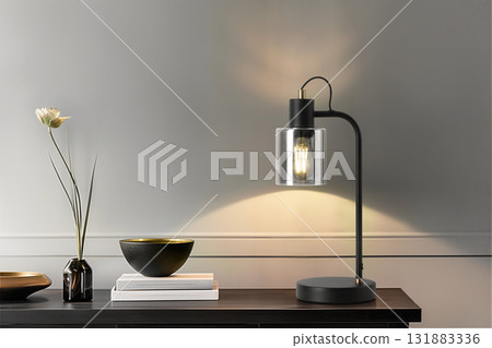 Modern table lamp with glass shade and decorative elements on a stylish wooden surface Modern table lamp with glass shade and decorative elements on a stylish wooden surface 131883336