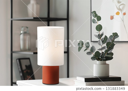 Modern table lamp with soft light and decorative plant in stylish interior design concept 131883349