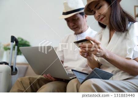 Finance and Planning. A retired couple discusses budgeting for their upcoming trip. 131883440