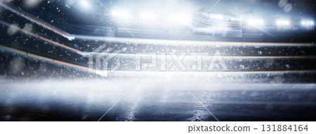 Professional hockey stadium. Ice. Hockey stadium view. Rink. Professional sports background for advertisement with lights, fans and flags. Big sport Professional hockey stadium. Ice. Hockey stadium view. Rink. Professional sports background for advertisement with lights, fans and flags. Big sport 131884164