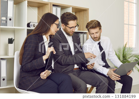 Business people or job seekers sitting in office in row discussing work project and talking. Business people or job seekers sitting in office in row discussing work project and talking. 131884199