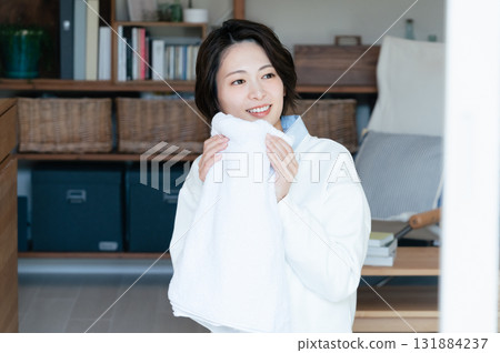 Young woman smelling the laundry 131884237