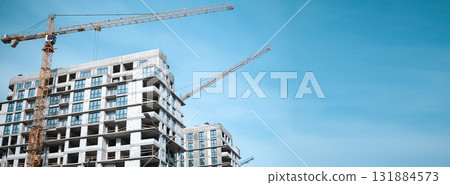 Construction crane in the construction of multi-storey buildings. High quality photo Construction crane in the construction of multi-storey buildings. High quality photo 131884573