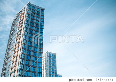 Multi-storey building on the background of blue sky. High quality photo Multi-storey building on the background of blue sky. High quality photo 131884574