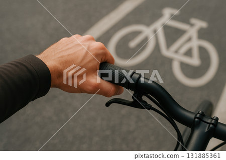 Close up of cyclist's hand gripping bicycle handlebar on urban bike lane with clear road marking in daylight, AI Generative 131885361