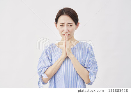 Woman, middle-aged, begging, hands together in prayer, white background Woman, middle-aged, begging, hands together in prayer, white background 131885428