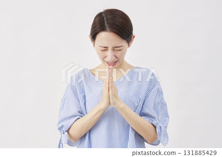 Woman, middle-aged, begging, hands together in prayer, white background Woman, middle-aged, begging, hands together in prayer, white background 131885429