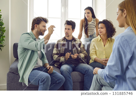 Group of young friends gather on the sofa at home, tell stories or play charades 131885746