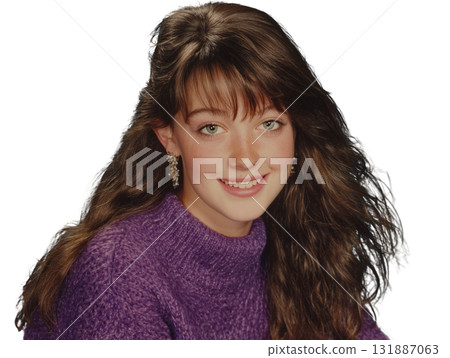 Young girl with long brown hair purple sweater smiling with earring, cheerful portrait with natural freckles and soft lighting 131887063
