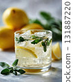 Refreshing lemonade with lemon slice ice sparkling water mint leaf cold beverage citrus drink glass on marble surface summer refreshment condensation natural garnish 131887220