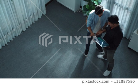 Top view of business man stand with investor while holding tablet. Convocation. Top view of business man stand with investor while holding tablet. Convocation. 131887580