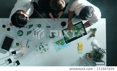 Top view of manager hold tablet display clean energy at meeting. Alimentation. Top view of manager hold tablet display clean energy at meeting. Alimentation. 131887834