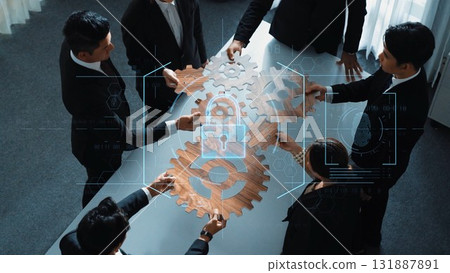 Business team collaborating with gears and digital security overlay on a table in a modern office setting for innovation and teamwork concepts. Raster 131887891
