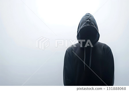 Silhouette of a hacker wearing a black hood 131888068