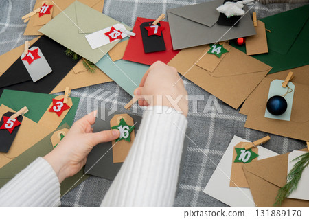 Step by step instruction of making handmade Christmas advent calendar with envelopes. Creative craft homemade decor. New year celebration. Winter Step by step instruction of making handmade Christmas advent calendar with envelopes. Creative craft homemade decor. New year celebration. Winter 131889170