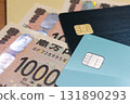 Credit card placed on top of banknotes 131890293