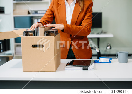Happy and excited young beautiful Asian woman office worker celebrating her resignation, carrying her personal stuff. Happy and excited young beautiful Asian woman office worker celebrating her resignation, carrying her personal stuff. 131890364