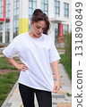 A Stylish and Fashionable Young Woman Dressed in a Casual Outfit, Enjoying the Outdoors 131890849