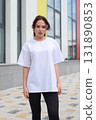 A Stylish and Fashionable Young Woman Dressed in a Casual Outfit, Enjoying the Outdoors 131890853