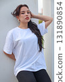 A Fashionable Young Woman is seen wearing a Casual White TShirt with style and flair 131890854