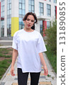 A Stylish and Fashionable Young Woman Dressed in a Casual Outfit, Enjoying the Outdoors 131890855