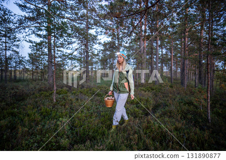 Happy tired middle-aged woman forager enjoying final moments of long day satisfying seasonal hobby Happy tired middle-aged woman forager enjoying final moments of long day satisfying seasonal hobby 131890877