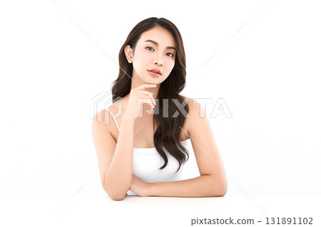 A beautiful young Asian woman with clean, fresh skin against a white background. Skincare, facial treatment, cosmetology, beauty, and spa. An elegant portrait of an Asian woman. 131891102