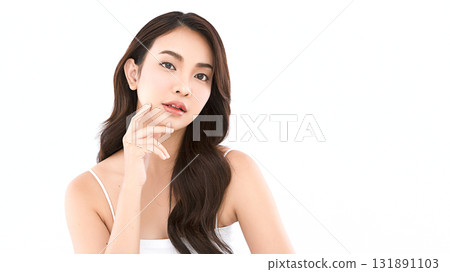 A beautiful young Asian woman with clean, fresh skin against a white background. Skincare, facial treatment, cosmetology, beauty, and spa. An elegant portrait of an Asian woman. 131891103