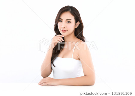 A beautiful young Asian woman with clean, fresh skin against a white background. Skincare, facial treatment, cosmetology, beauty, and spa. An elegant portrait of an Asian woman. 131891109
