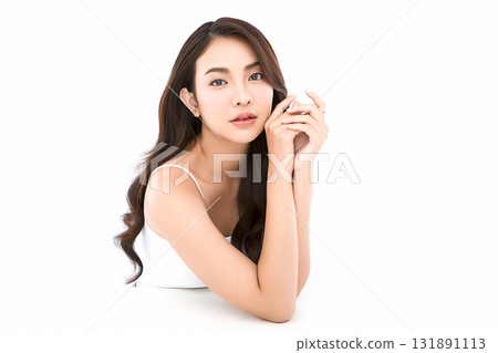 A beautiful young Asian woman with clean, fresh skin against a white background. Skincare, facial treatment, cosmetology, beauty, and spa. An elegant portrait of an Asian woman. 131891113