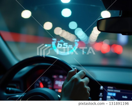 Driver's perspective of a futuristic car dashboard with glowing HUD navigation data projected onto the windshield while driving at night. Driver's perspective of a futuristic car dashboard with glowing HUD navigation data projected onto the windshield while driving at night. 131891196