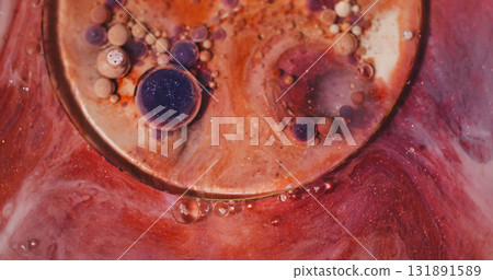 Ink stream. Oil bubbles. Defocused orange purple vibrant color glitter acrylic fluid round emulsion floating on abstract background. Ink stream. Oil bubbles. Defocused orange purple vibrant color glitter acrylic fluid round emulsion floating on abstract background. 131891589