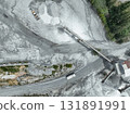 Aerial view of granite and limestone crushing plant with dump trucks and excavators processing raw stone into construction aggregates for concrete and infrastructure development. Stone mill factory. 131891991